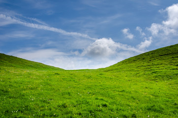 Green hill and a blue sky