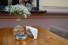 Table In A Street Cafe With Flowers