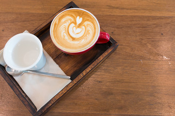 a red cup of latte art coffee