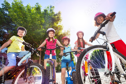 Fotografie, Obraz Happy children with their bicycles in summer park