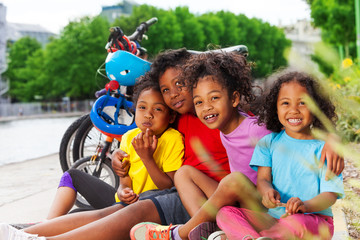 Wall Mural - Happy African children resting after cycling