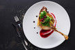 © Prostock-studio - Restaurant meals. Duck confit with vegetables on black background