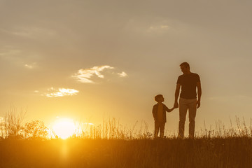 Friendly family walking on grass field together