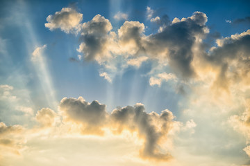 Wall Mural - colorful dramatic sky with clouds and sunbeams at sunset.
