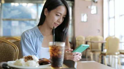 Poster - Woman use of smart phone in restaurant