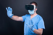 © Catalin Pop - Surgeon wearing scrubs using virtual reality glasses