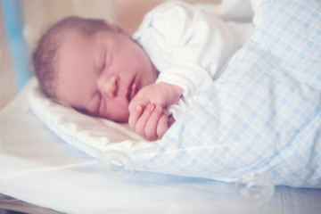 Wall Mural - Newborn baby laying in crib in prenatal hospital