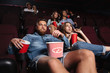 Impolite rude couple sitting in a cinema