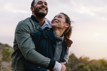 Romantic young couple embracing in nature