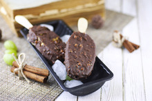 Dessert Chocolate Ice Cream With Nuts On Wooden Stick