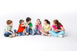 © Prostock-studio - Happy kids sitting on floor at studio, copy space