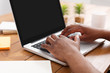 © Prostock-studio - African-american businessman in office type on laptop