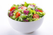 Fresh salad in a bowl. Healthy lettuce and tomato meal on white background