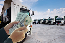 People Hands Are Taking Money To Buy New Truck Fleet As In Business Logistics Concept.
