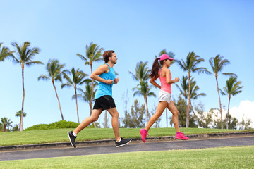 Wall Mural - Sport fitness runners couple running lifestyle. Healthy people jogging together in summer city park outdoor, athletes training cardio on sidewalk.