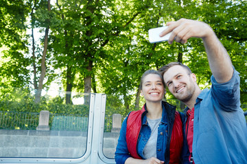 Canvas Print - Young adventurers making selfie while traveling on steamer