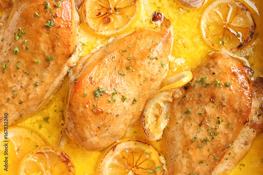 Delicious chicken breasts with lemon and sauce, closeup