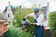© Julien L. Balmer/Stocksy - Outdoor Portrait of Elderly Hipster Using Watering Can on Rooftop Terrace