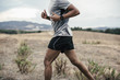 © BONNINSTUDIO/Stocksy - Anonymous man running on a field.