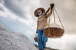 Worker transporting salt in special containers