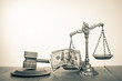 Law scales with cash money, judge gavel on table. Vintage old style sepia photo