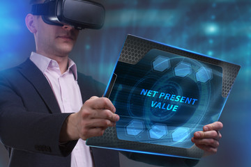 Business, Technology, Internet and network concept. Young businessman working on a virtual screen of the future and sees the inscription: Net present value