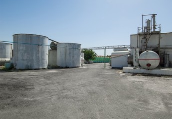 reservoir in a row and a building on a farm. heavy industrial plant