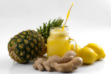 Juicing Raw Fruits And Vegetables And Juice Extractor Recipes Concept With Pineapple, Lemon And Ginger, The Ingredients For A Detox Smoothie That Helps With Inflammation And Digestion