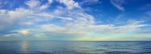 Panoramic View Rippled Surface Of Cold Sea At Sunrise
