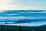 Fototapeta Na ścianę - Breathtaking sunrise and mist over the tops of mountains and woods
