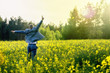 © bint87 - Young and attractive man in a suit jumping in yellow rape field and looking somewhere.