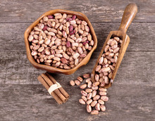 Colored Beans In A Wooden Bowl On An Old Wooden Background