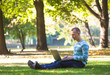 © lkoimages - Happy student study with laptop in city park