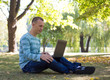 © lkoimages - Happy student study with laptop in city park