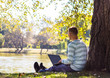 © lkoimages - Happy student study with laptop in city park