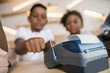 african-american kids paying with credit card