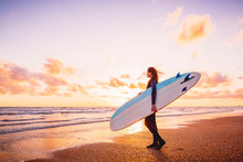 Surf Girl Holding Surfboard At Warm Sunset Or Sunrise And Ocean.