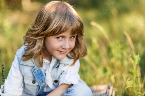 A Portrait Of A Cute Little Boy With Blue Eyes And Long Blond Hair