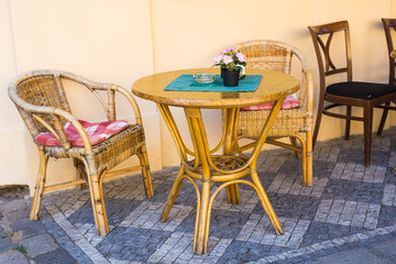 Old fashioned cafe terrace. Tables and wicker chairs in a cafe