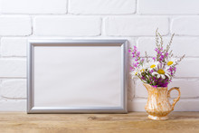 Silver Landscape Frame Mockup With Chamomile And Purple Flowers In Golden Pitcher