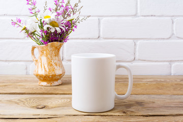 White coffee mug mockup with chamomile and purple flowers in golden pitcher