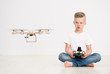 © Ermolaev Alexandr - Boy is operating the drone by remote control
