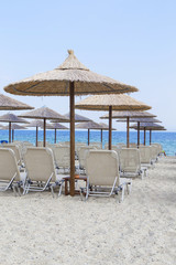 Wall Mural - Sun umbrella and beach beds on tropical coastline