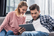© LIGHTFIELD STUDIOS - couple using digital tablet