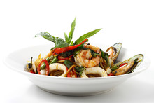 Stir-fried Spicy Spaghetti Seafood Thai Style (Spaghetti Pad Kee Mao) On White Dish, Isolated On White Background With Shadow, Front Side View. Selective Focus At The Front.