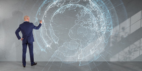 Wall Mural - Businessman using digital planet earth interface on a wall 3D rendering