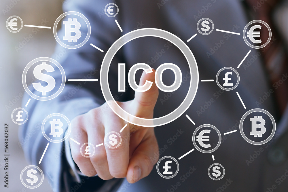 Businessman presses currencies button ICO Initial Coin Offering on a virtual digital electronic user interface.