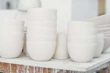 Unglazed White Ceramic Bowls In A Studio