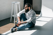 © LIGHTFIELD STUDIOS - handsome man sitting on floor