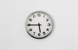 © Peter - White Clock hanging on a white wall showing time 5:45